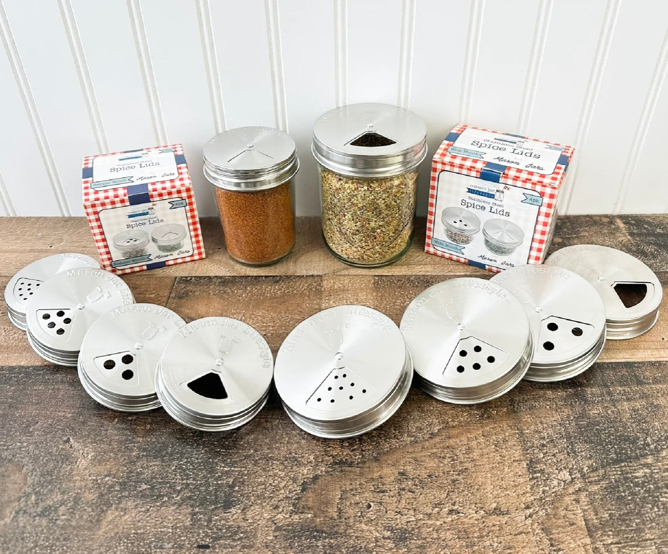 Set of metal mason jar spice lids with varying sized spice dispensers. 