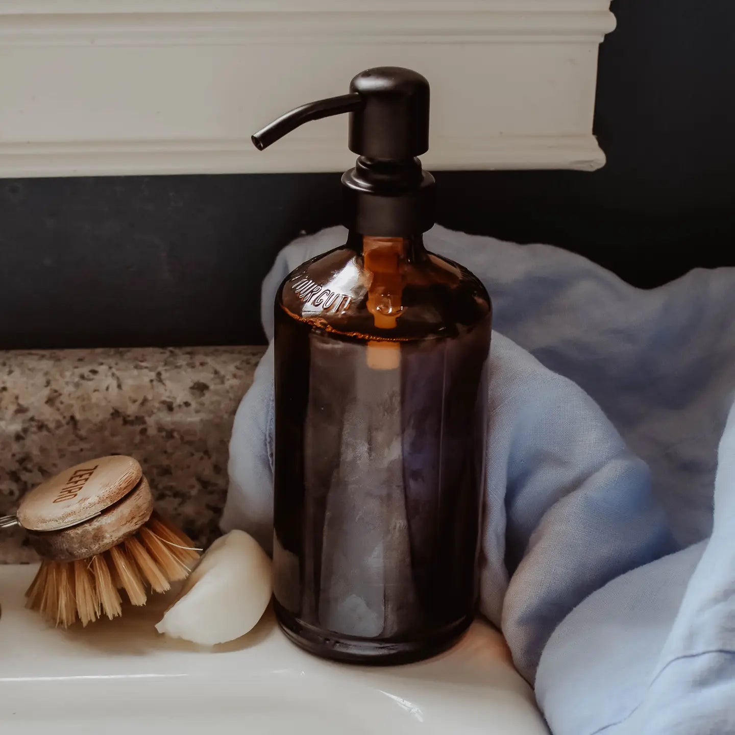 Matte black pump top on glass bottle. 