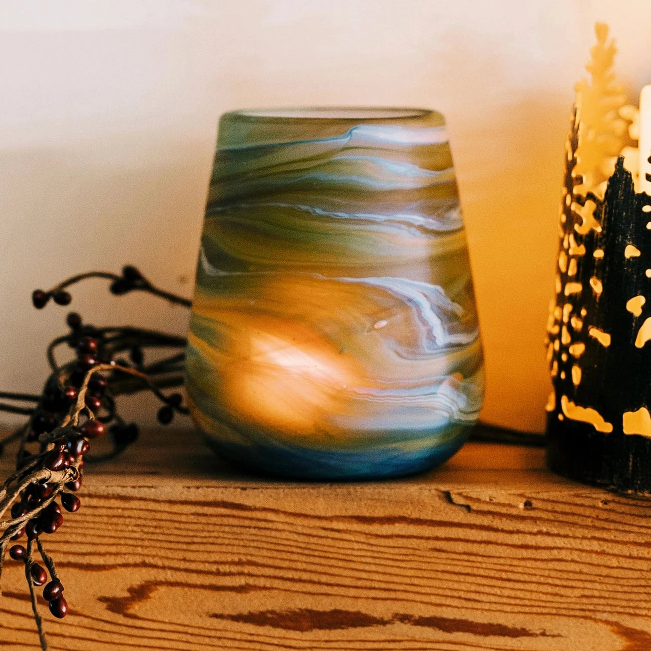 Glass blown multi color candle holder.