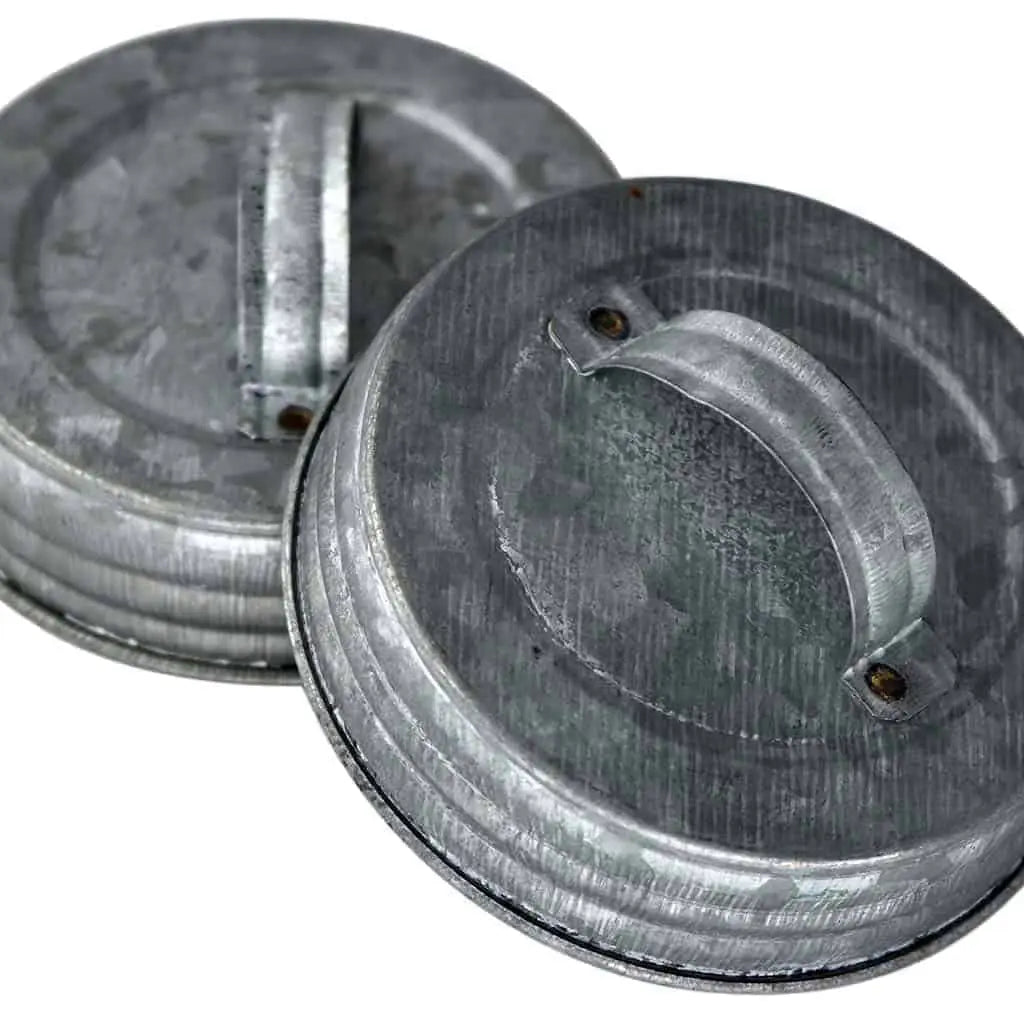 Two metal lids with handles. 