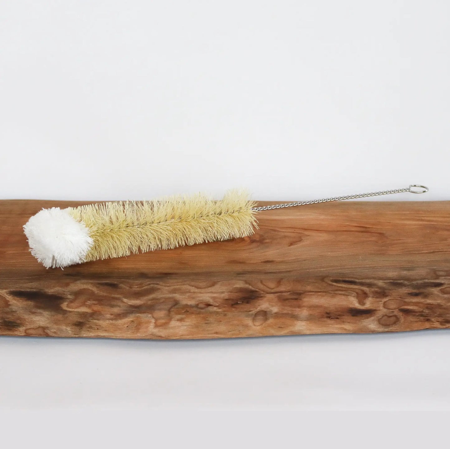 Bottle brush with cotton tip and metal handle. 