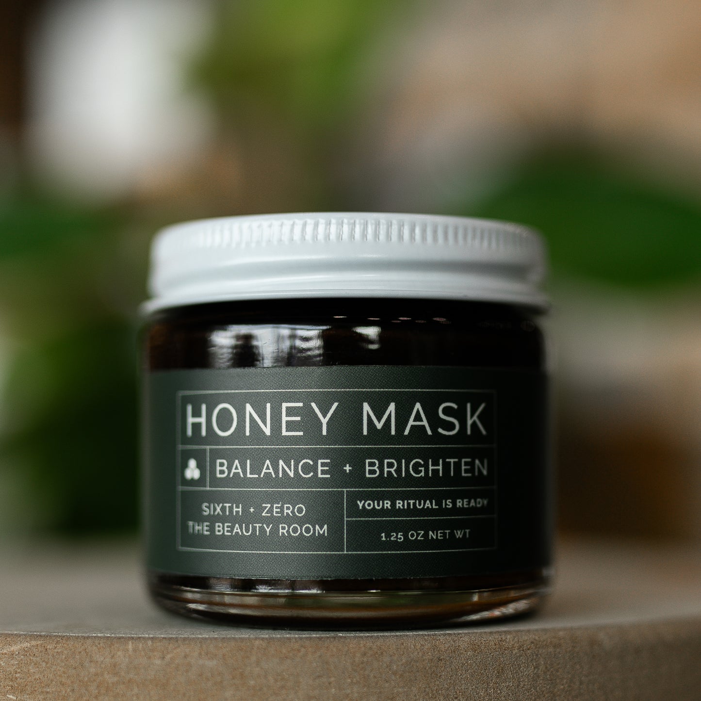 A jar labeled 'HONEY MASK BALANCE + BRIGHTEN'
