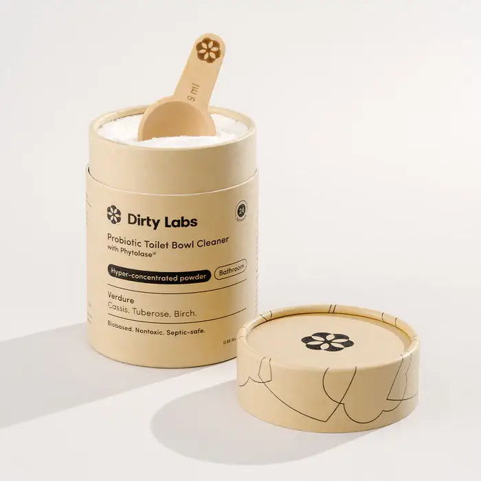 Probiotic toilet bowl cleaner with wooden scoop from Dirty Labs on a white background