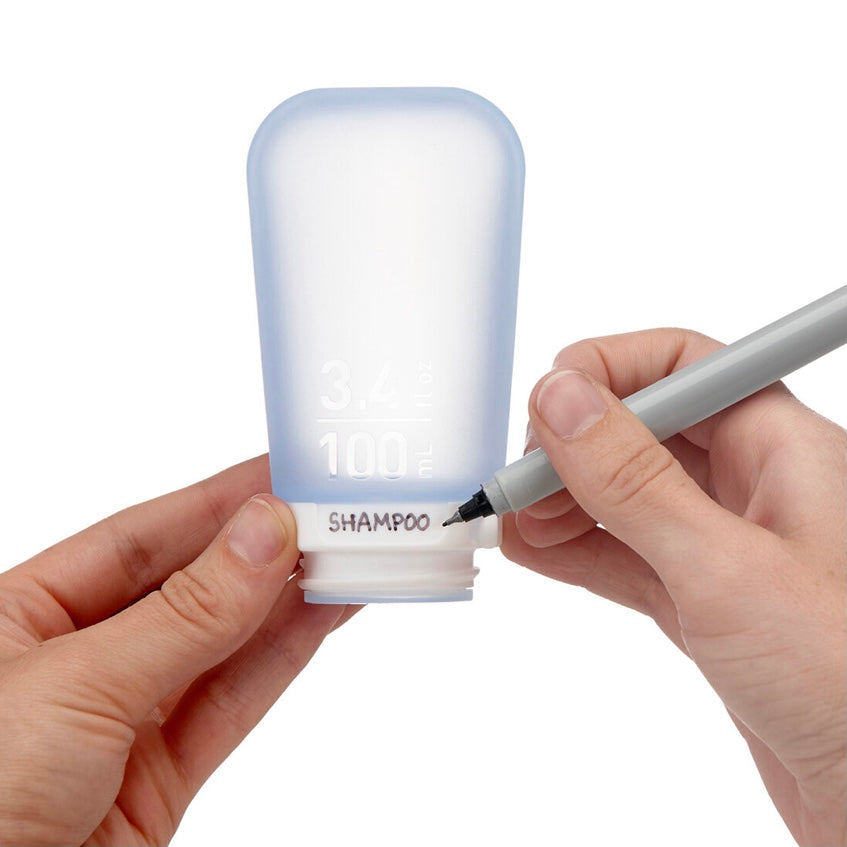 Person using GoToob’s textured area by the collar for writing shampoo.