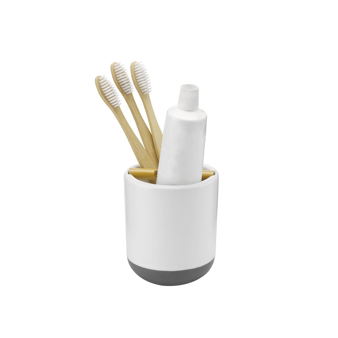 full circle home toothbrush holder with toothpaste and toothbrushes inserted.